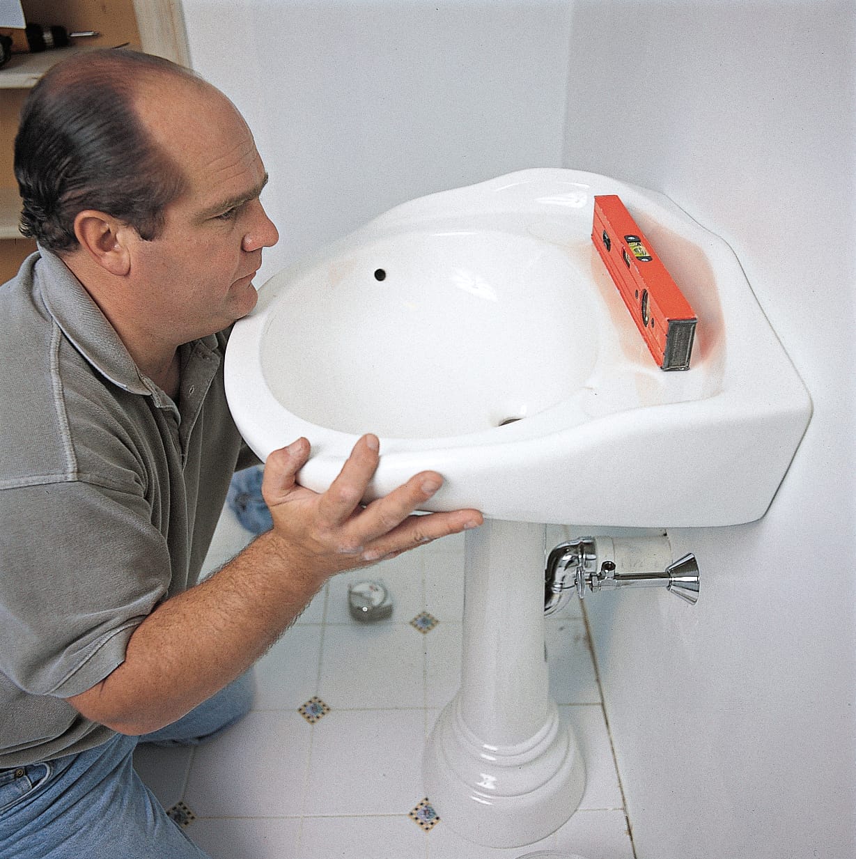 Drain assembly of a pedestal sink is installed.