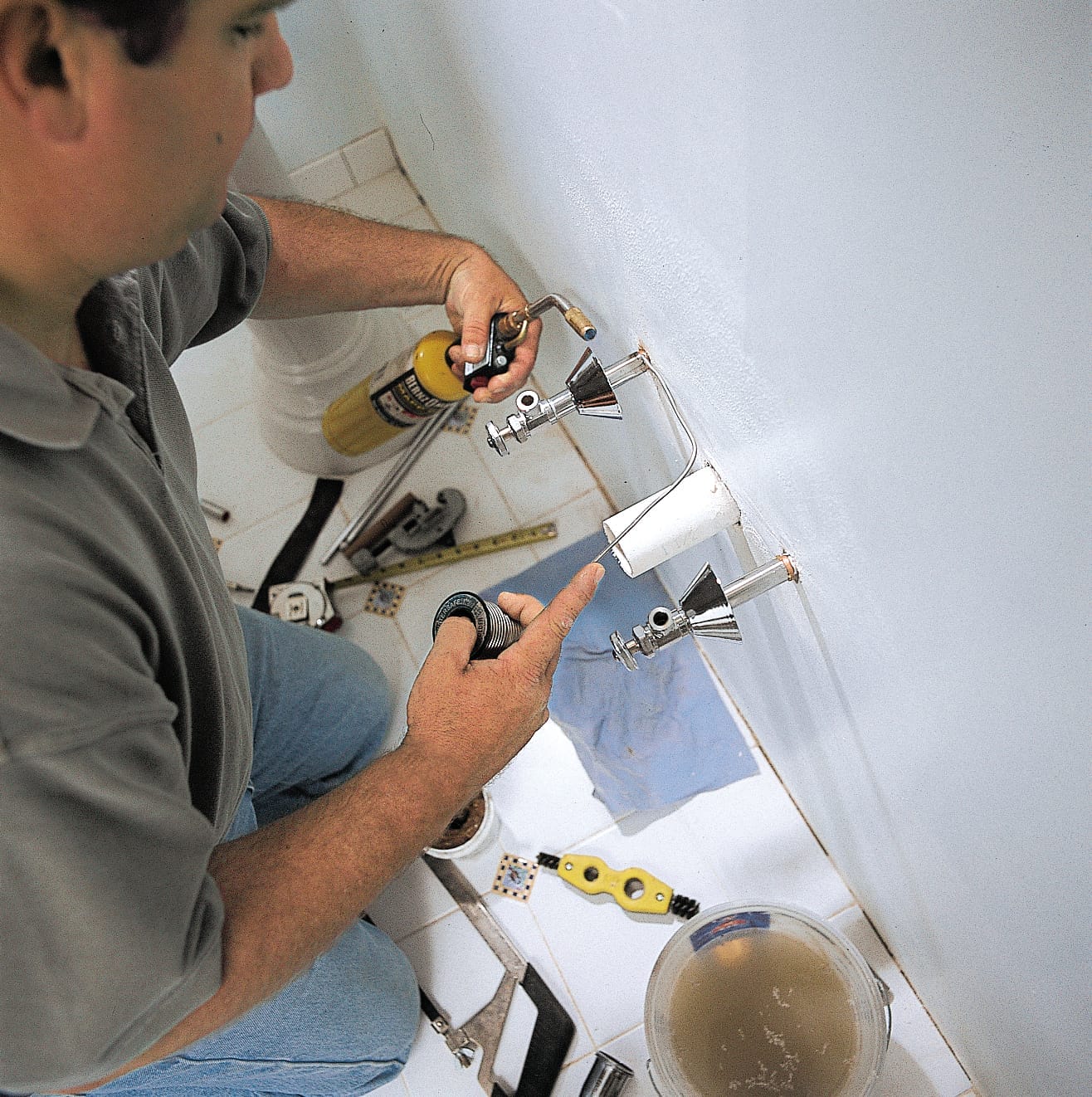 The supply lines of a pedestal sink are soldered.