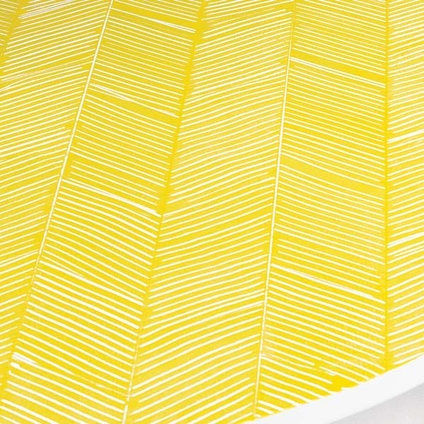A yellow herringbone pattern on a tabletop