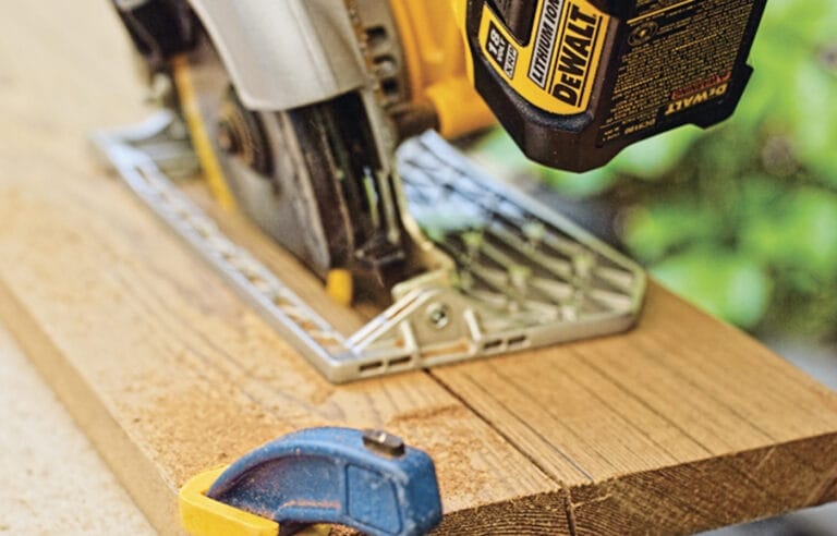 Photo of a person cutting the front legs of a Westport chair out of wood.