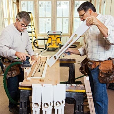 Men sanding balusters