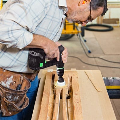 Man cutting the decorative baluster hole