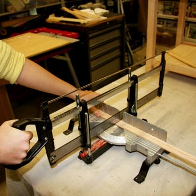 A person using a saw for table trimming