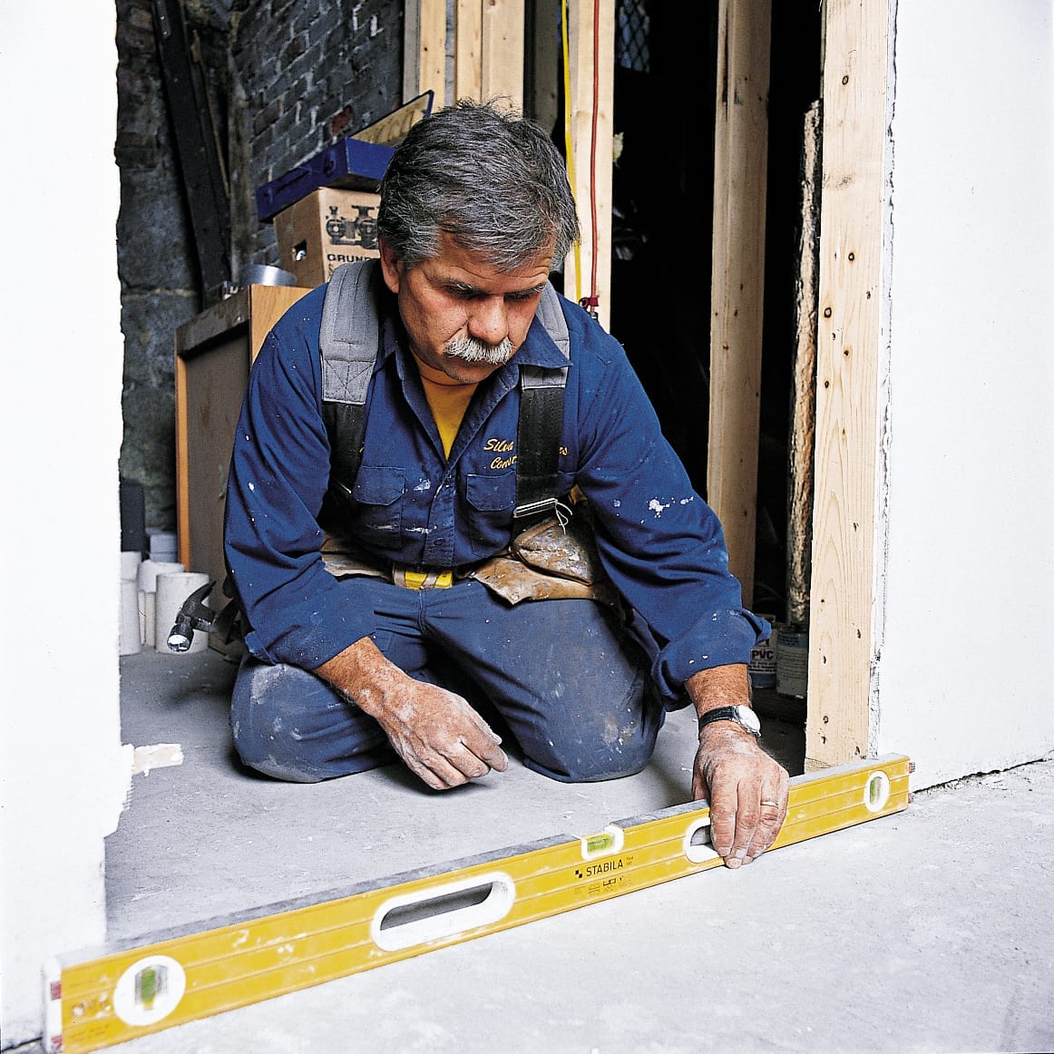Photo of Tom Silva measuring a prehung door's opening