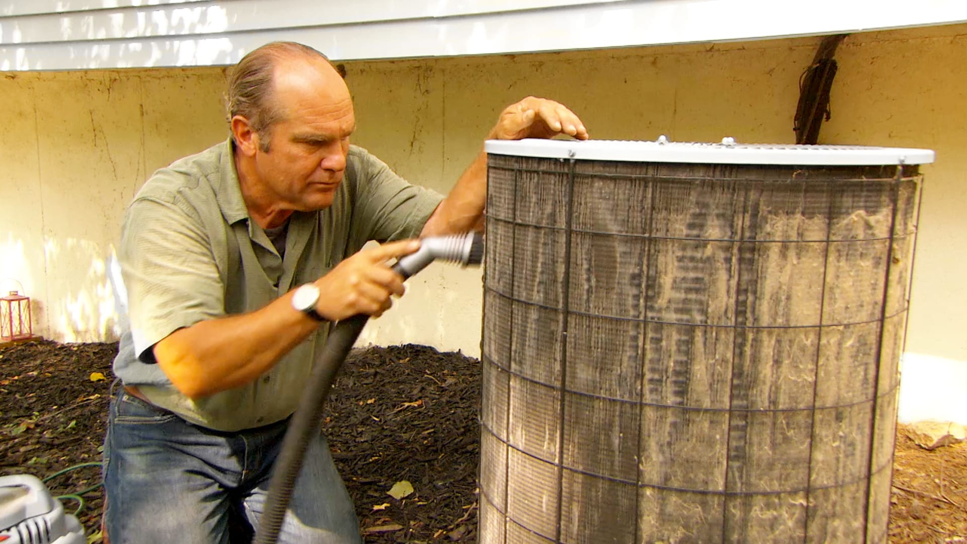 Person maintaining an AC unit.
