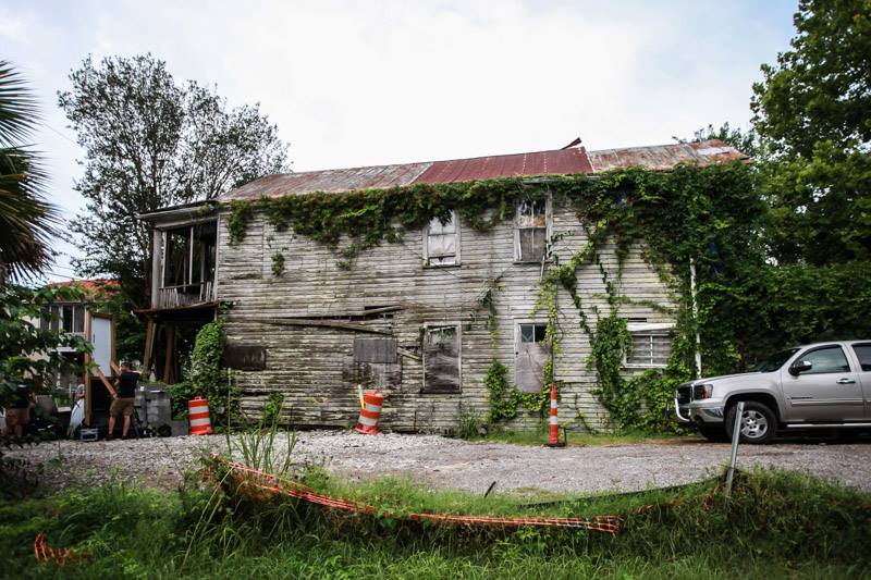 A two-story structure with crumbling walls and overgrown ivy.