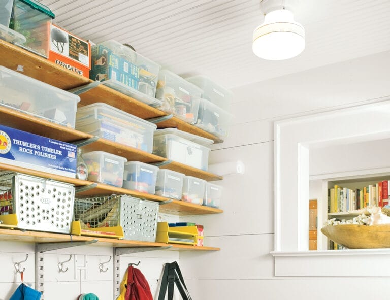an up close view of organized containers on shelves in a mudroom