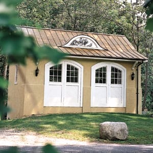 Builder Tim Lee inserted an expressive eyebrow window on the copper roof of a garage-turned-guesthouse in Locust Valley, New York.