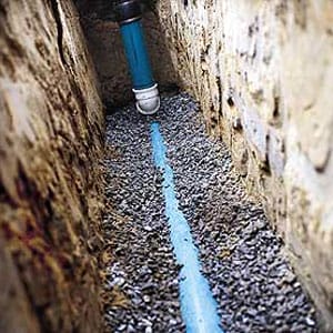 A sewer line laid on crushed stone.