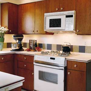 Microwave placed above the oven in the kitchen