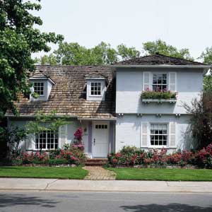 a home that is painted and dormers are added to enhance curb appeal