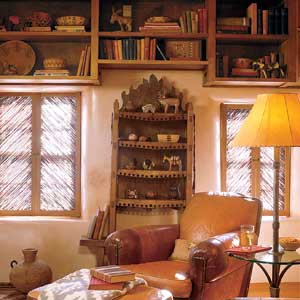 Window coverings made of salt-cedar twigs, called sombraje shutters, shield the study interior from the Sante Fe sun.
