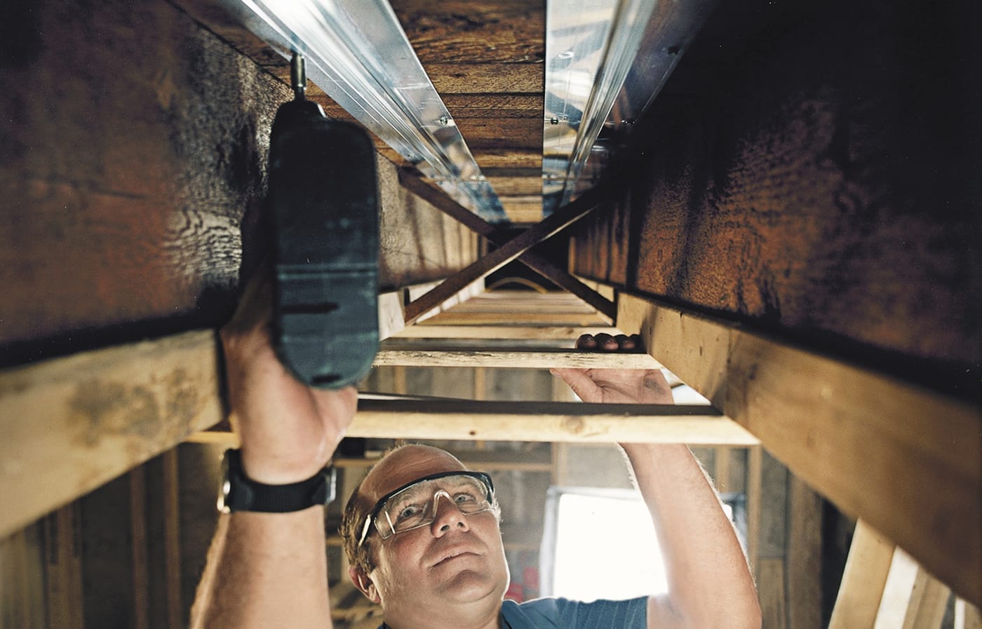 As a part of a home heating system, Richard Trethewey install radiant tubing in a house.