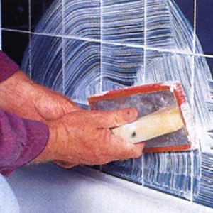 Image of a person re-grouting ceramic tile
