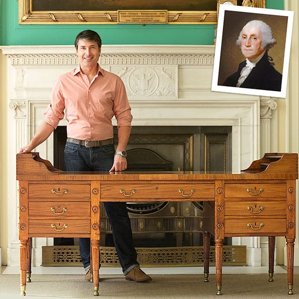 Man posing with heirloom desk.