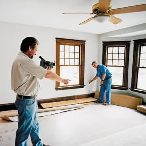 Man using an infrared camera in interior room.