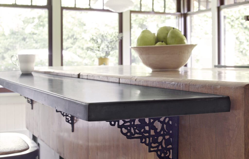Mounted breakfast bar with brown countertop.