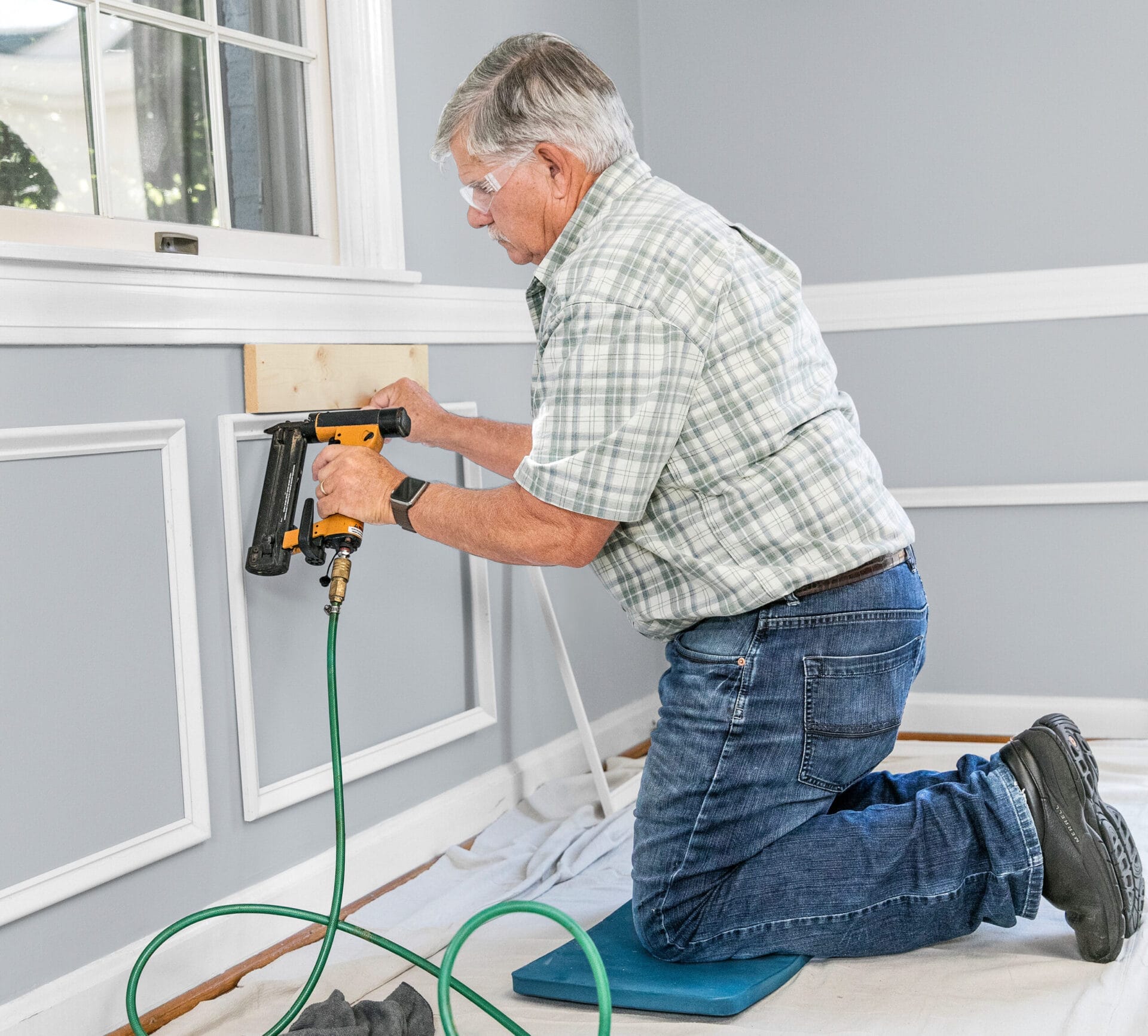 Tom Silva installing wainscoting.