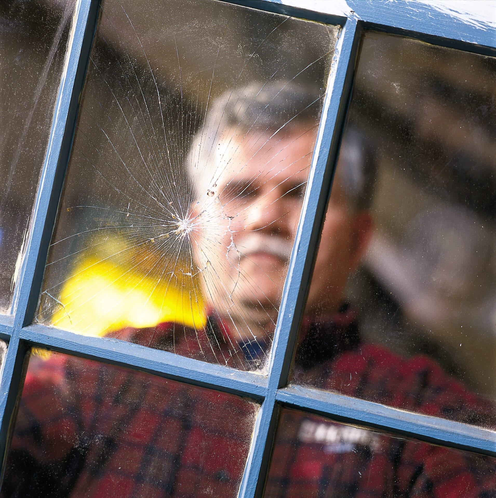 A man in front of a newly replaced window pane.