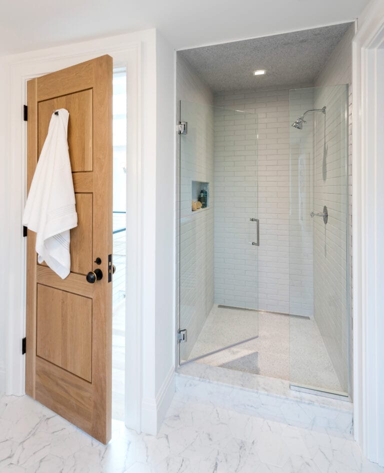 A view of the bathroom door and shower enclosure.