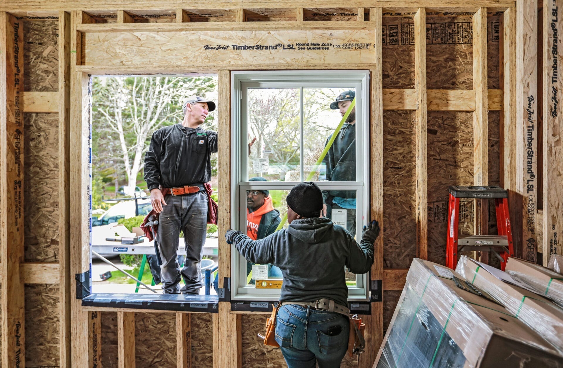 Jeff Sweenor and Ryan Dolan teaching apprentices window installation techniques.