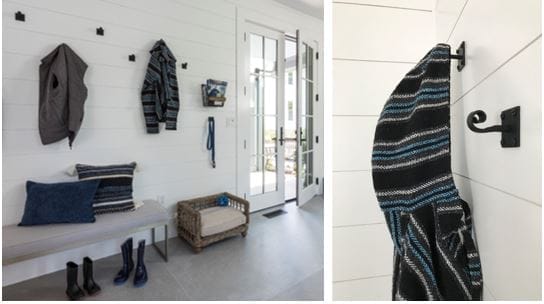 An entryway space with hooks for hanging clothing.