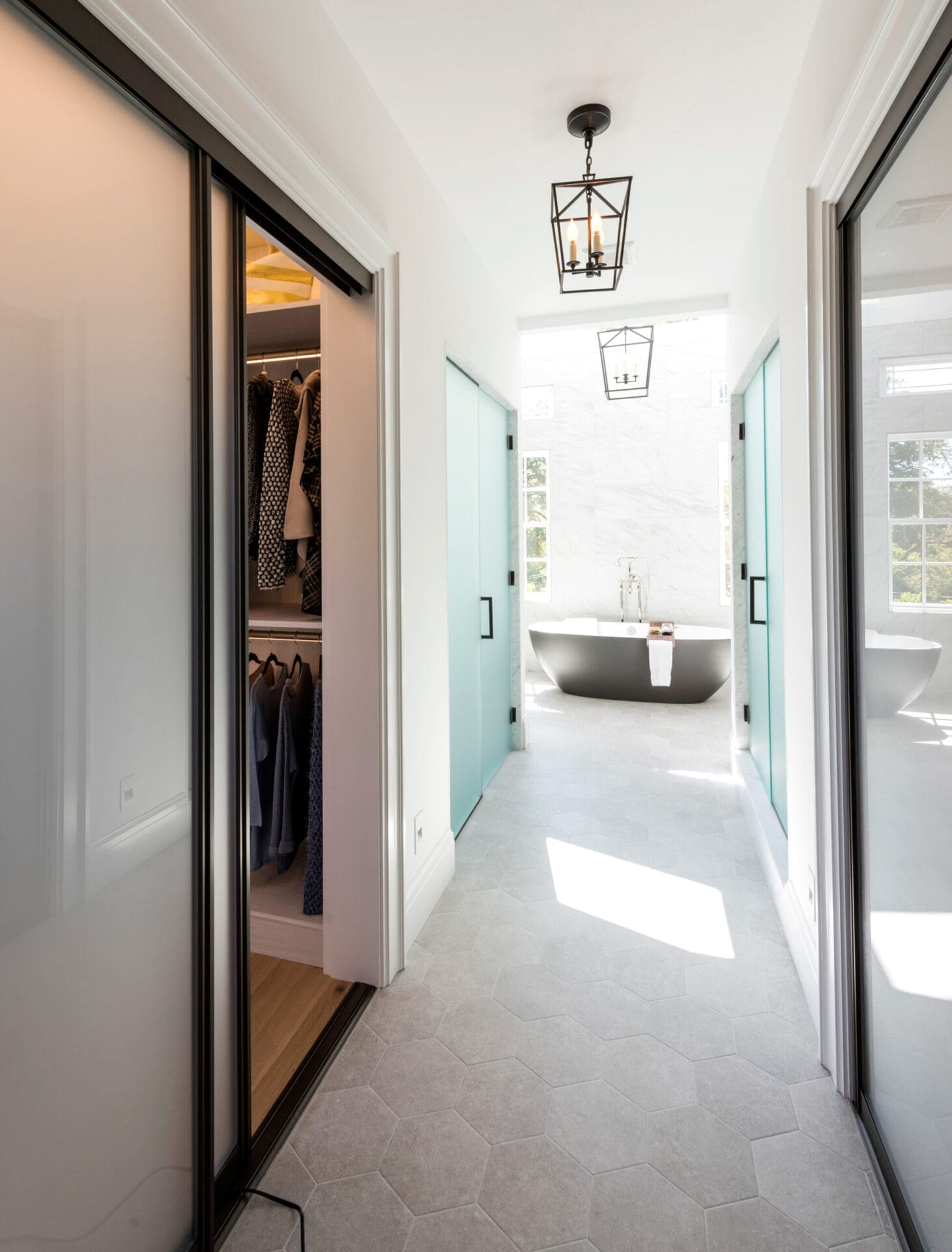 A view of the bathtub and master closet from a hallway.