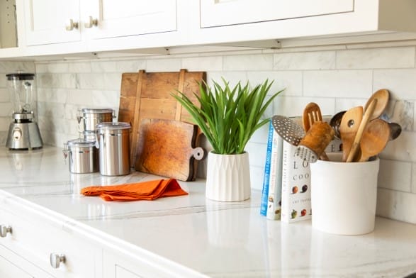 Cutting boards, appliances, and cookbooks on a kitchen counter.