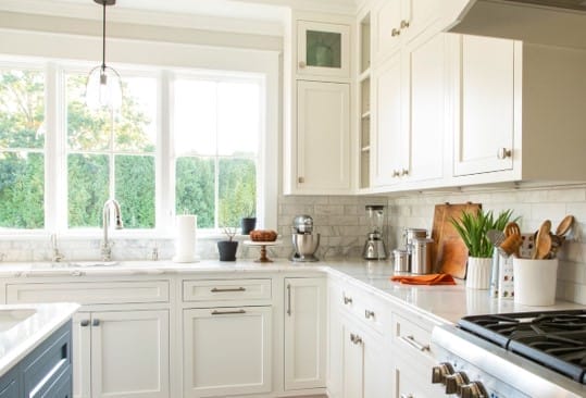 A view of the kitchen stovetop, counters, and sink.