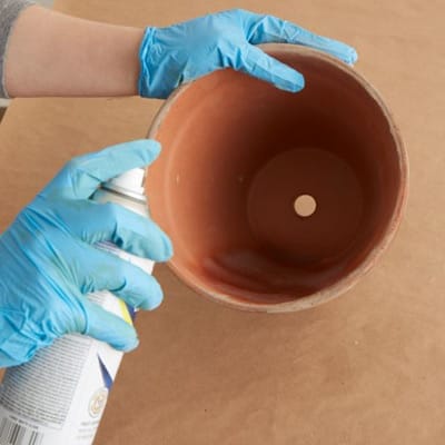 using the sealant spray to seal the inside and bottom of the terra-cotta pot as well