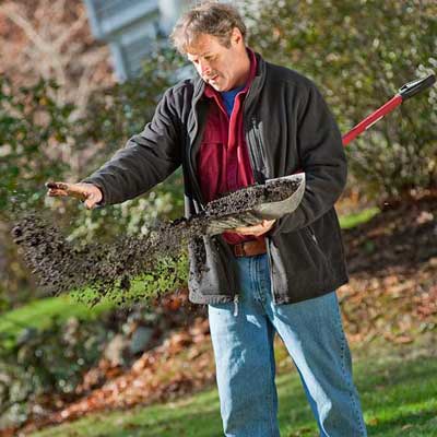Man sprinkling grass seed.
