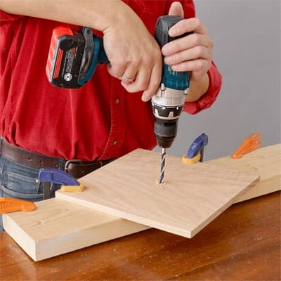 A drill being used to build a tiered serving tray.