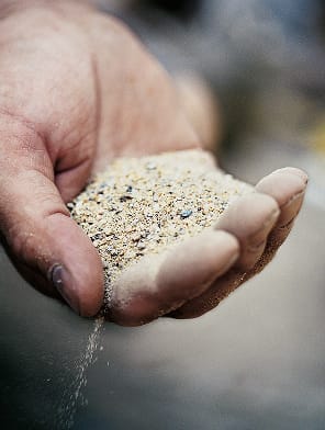 A man holding stucco in his hand.