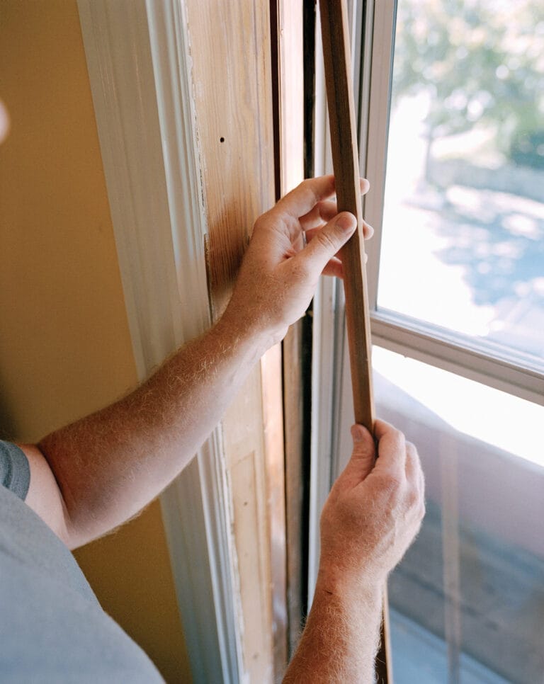 Image representing the third step of how to weatherstrip a double-hung window, which is to pull the parting beads
