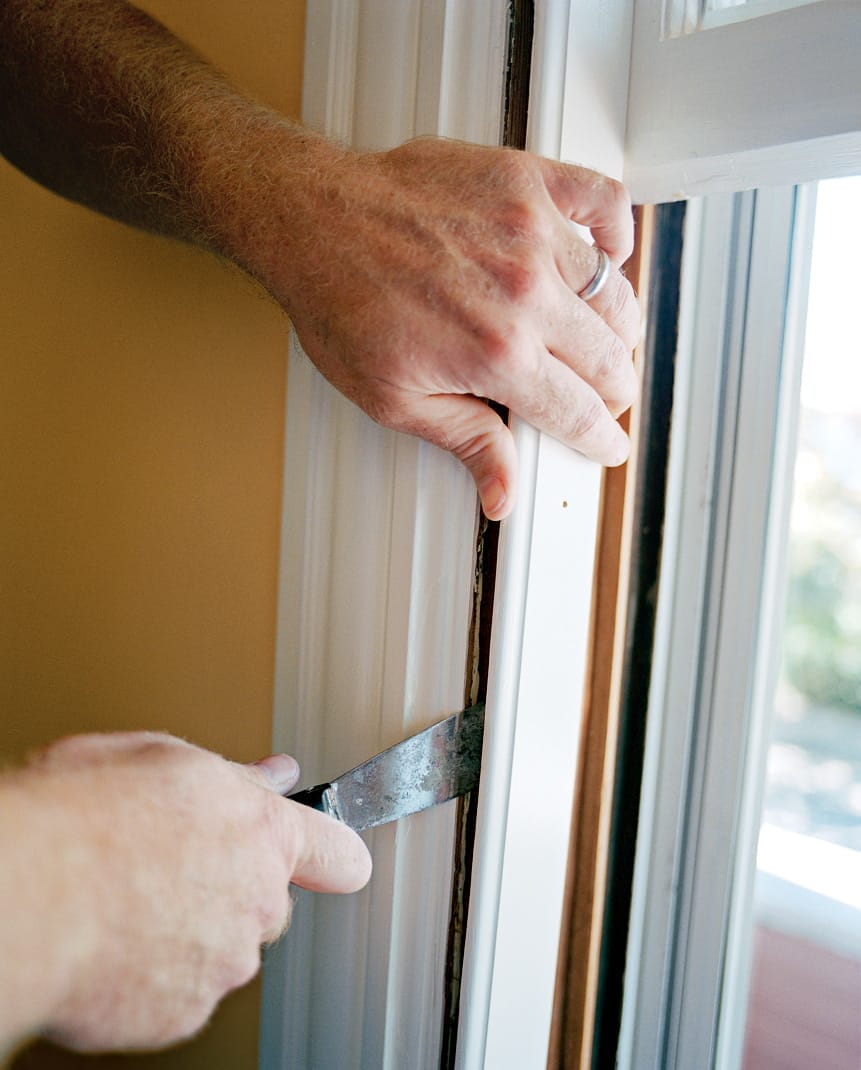 Image representing the first step of how to weatherstrip a double-hung window, which is to pry off one inside stop. 