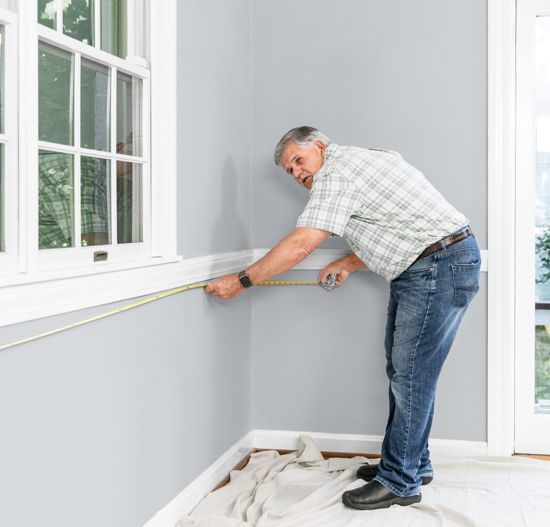Tom Silva measuring the room. 
