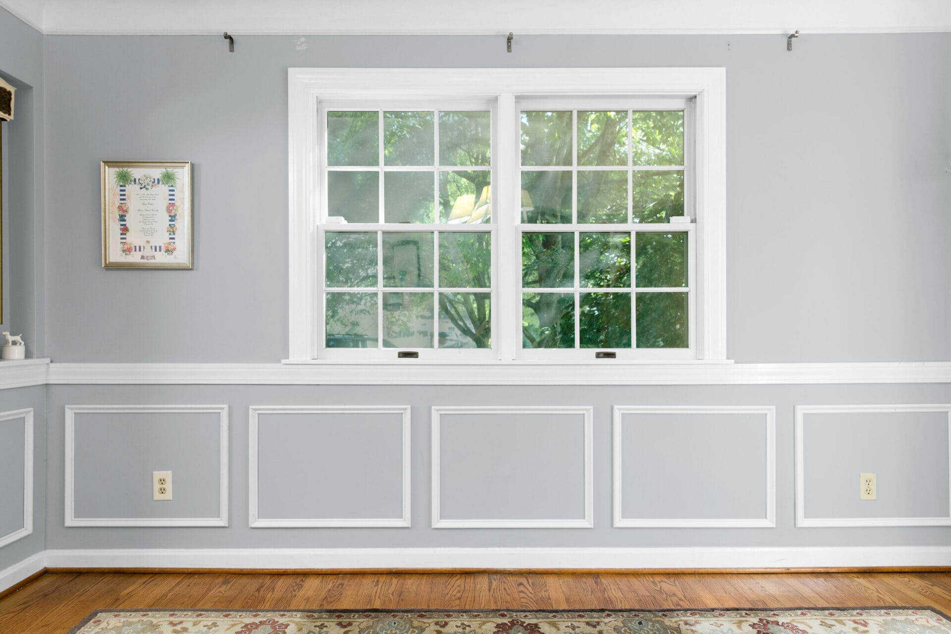 A room with a wide window in which wainscoting will be installed. 