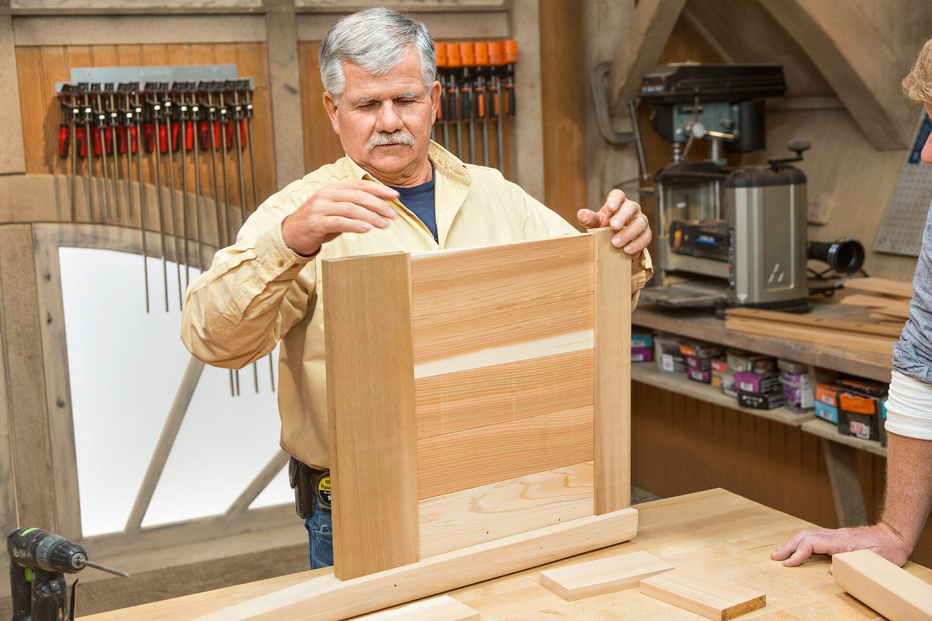 Tom Silva assembles the the first side of the cedar planter box.