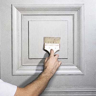 Toothed brush creating straight lines through glaze following panel shape.