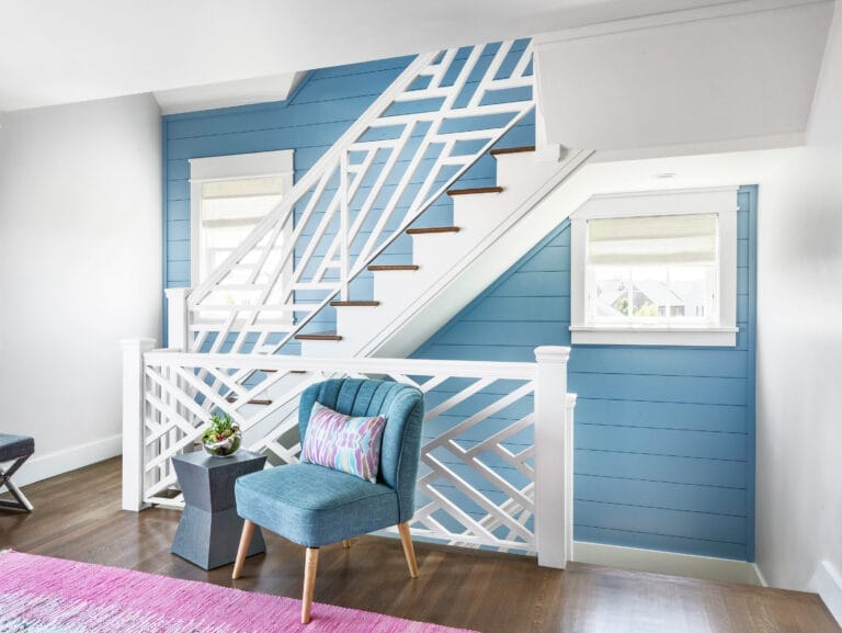 blue shiplap wooden paneling leading up and down the stairs