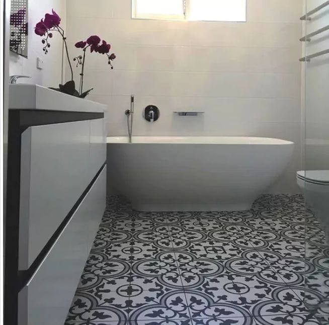 Patterned tiled floor in a bathroom.