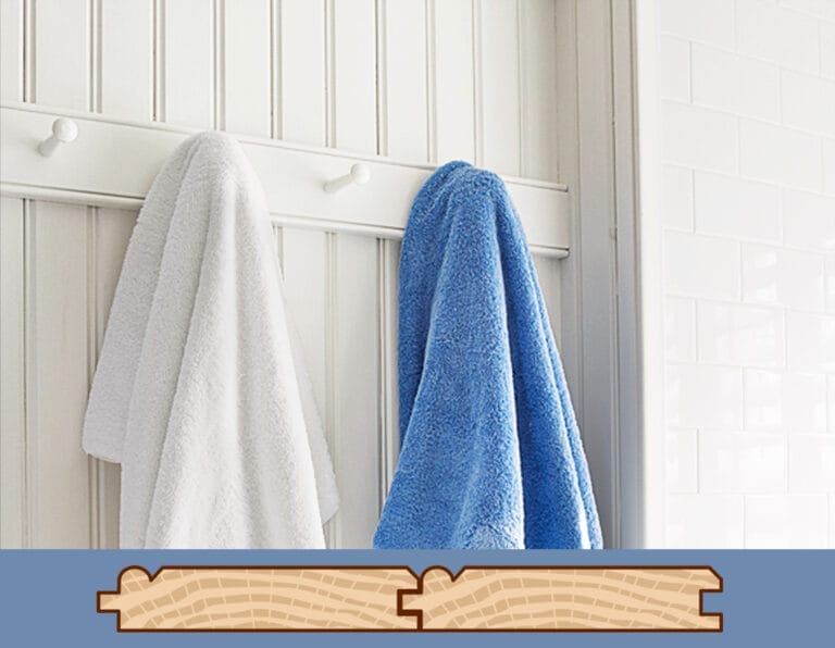 A door with bedboard paneling and clothing hooks.