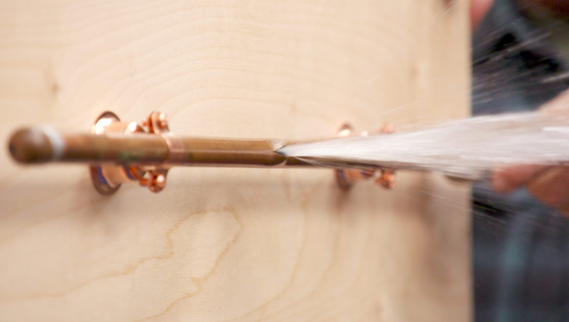 A burst pipe spraying water.