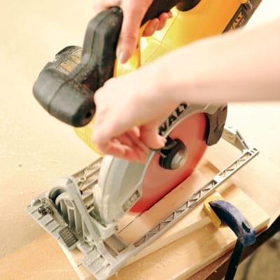 using a saw to cut the sides of the takeout menu bin