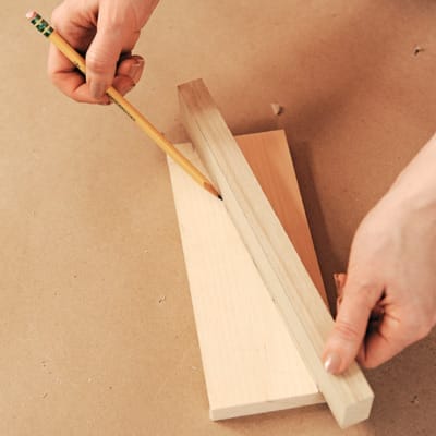using a pencil to help measure the sides of the menu bin