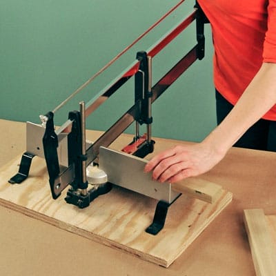 using a miter saw to cut frame pieces for a takeout menu holder