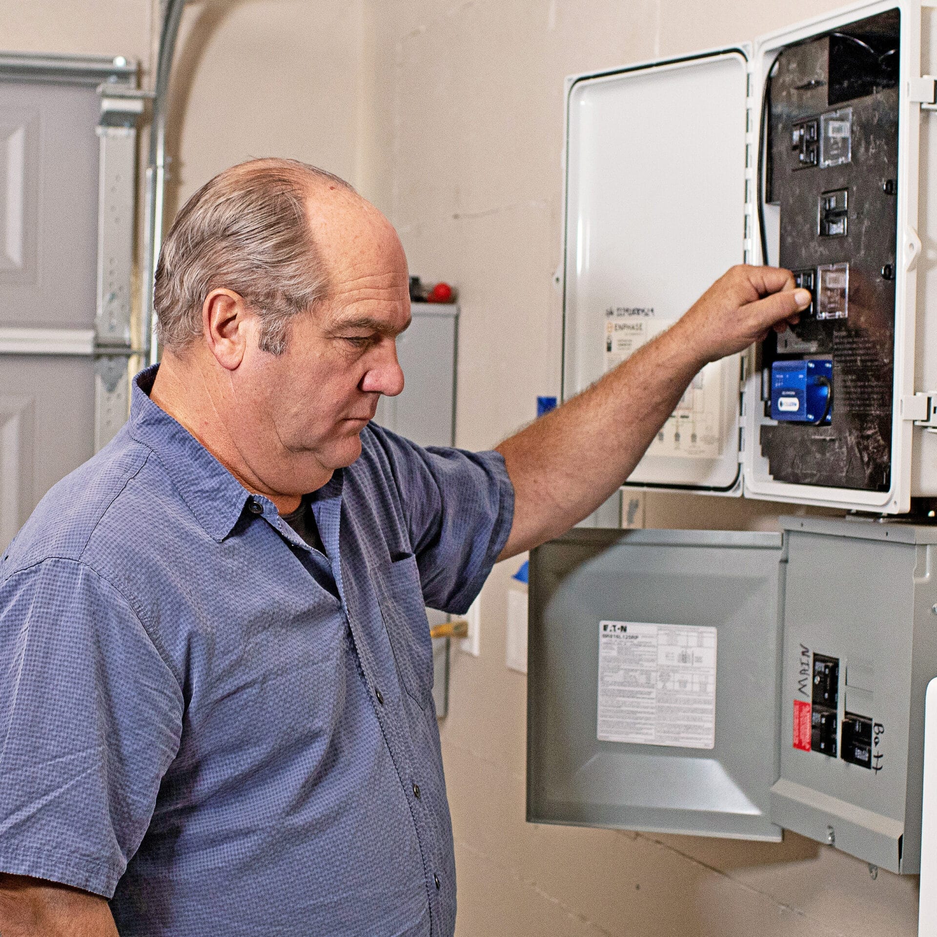 Richard Trethewey looking at an electrical panel.
