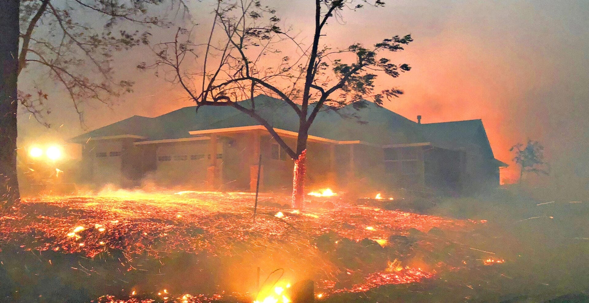 House engulfed in flames during the devastating Camp Fire in Paradise, California.