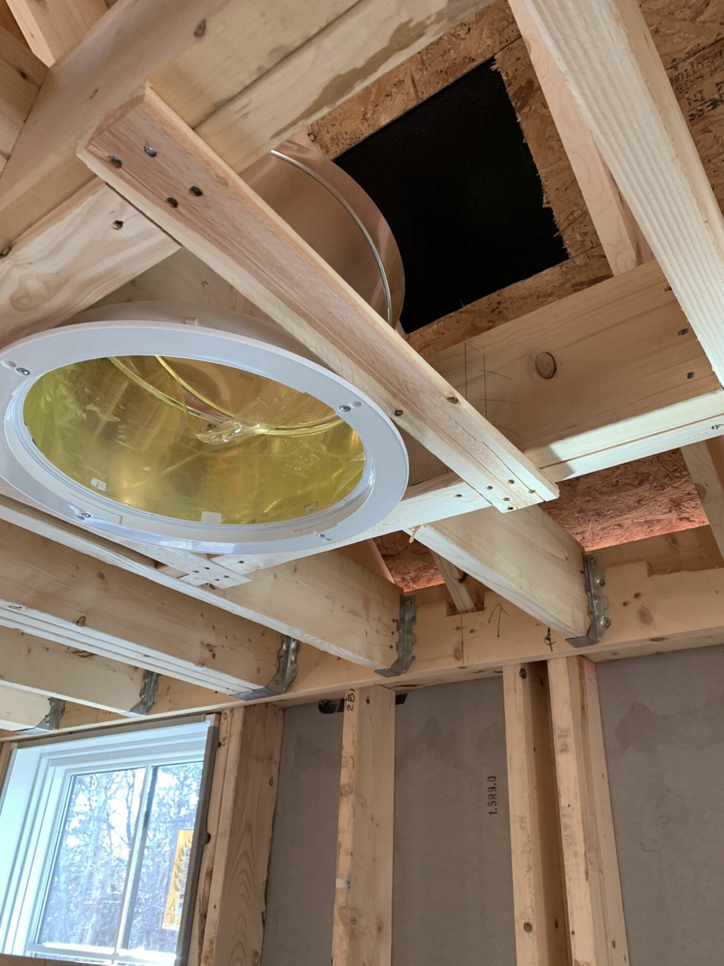 A sun tunnel being installed in a house.