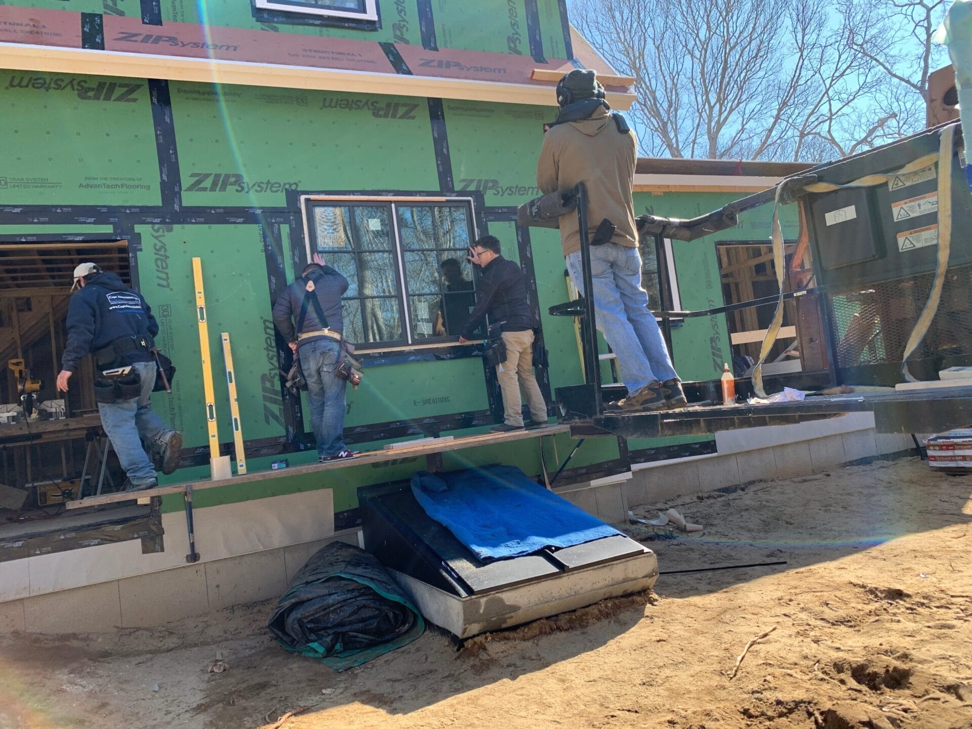 Crew members installing a window.